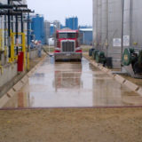 Truck entering wash bay containment pads